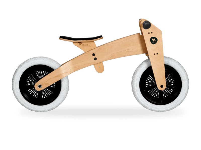 Wooden running bike in high mode