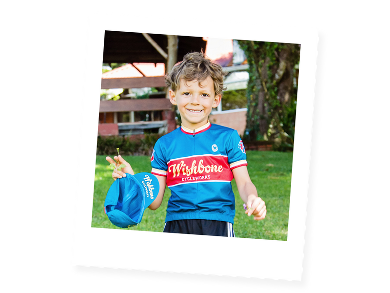 Blue, red and yellow cycling jersey worn by child