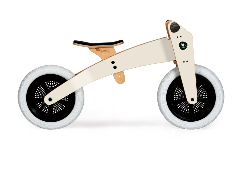 Off-white wooden running bike in high mode